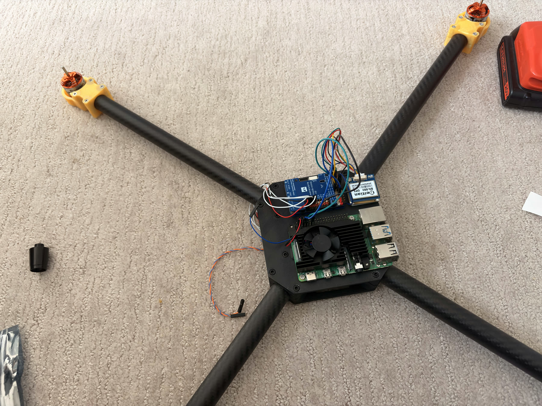 Raspberry Pi, flight controller, GPS module, and wiring mounted on the drone center deck.
