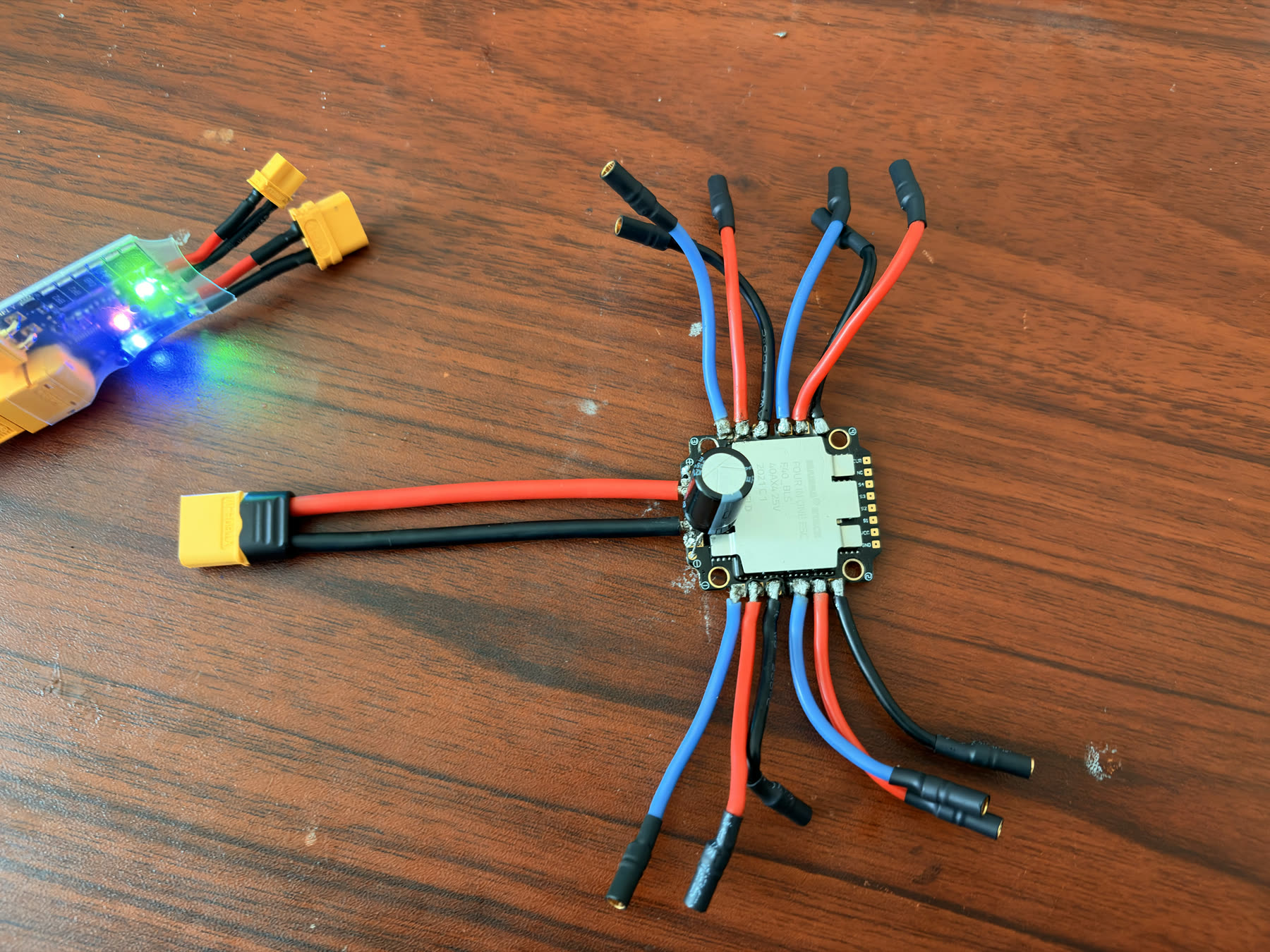 ESC bench test with XT60 leads, bullet connectors, and LiPo checker.